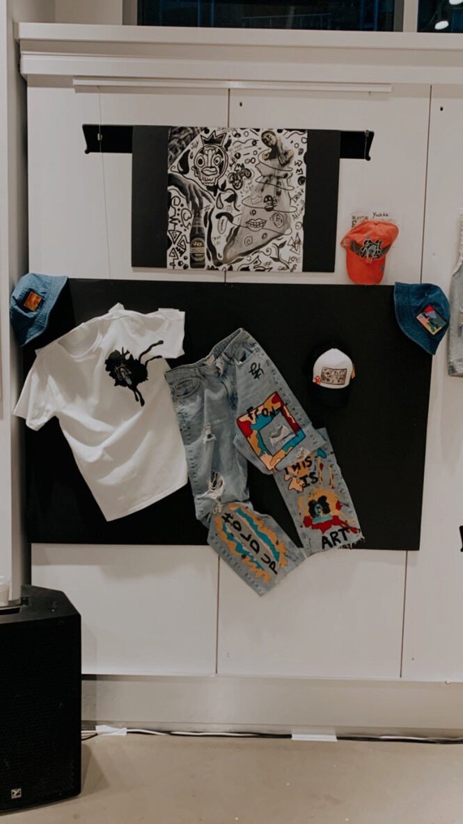 Gift shop wall: painted denim and one-of-one tees